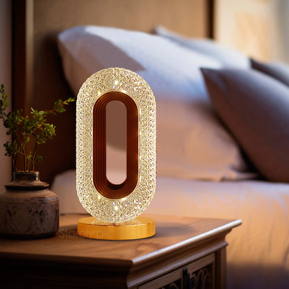 Oval Crystal LED Table Lamp with RGB lighting on a bedside table