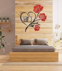 Multi-piece rose wall art set being arranged on a wall with the protective paper being removed.